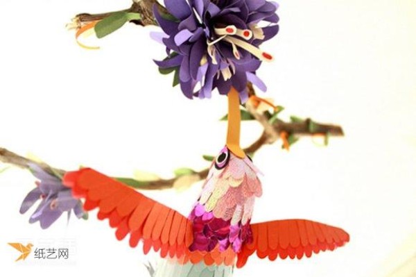 A realistic picture of a handmade paper bird in a world of singing birds and fragrance of flowers