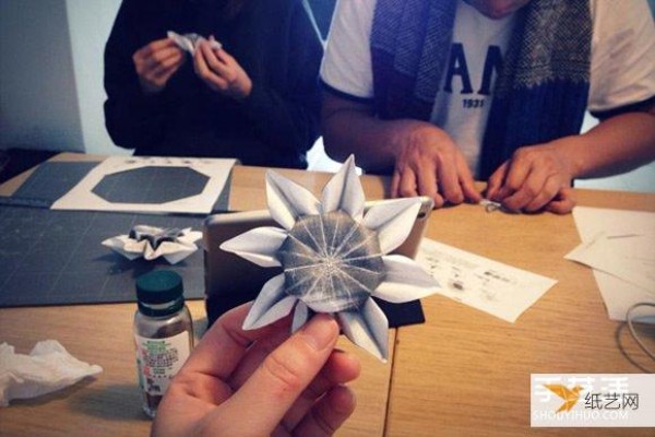 Illustration of the process of hand folding paper sunflower flowers