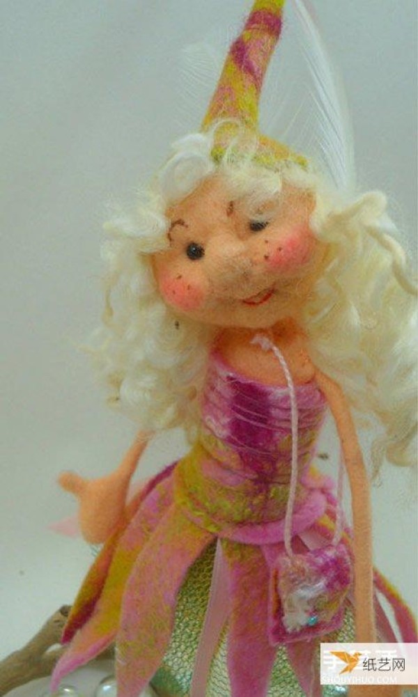 A particularly beautiful cartoon-style picture of a handmade wool felt girl doll