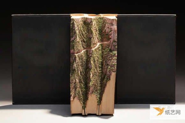 Transform the geography textbook directly into a super realistic book sculpture