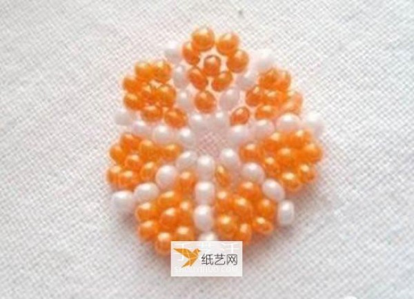 Use beads to create a personalized orange petal keychain