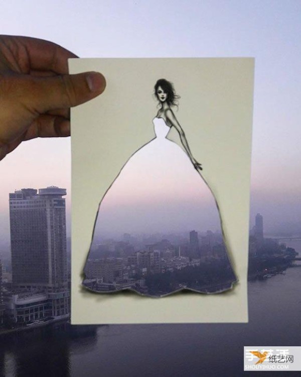 A very unique and creative paper-cut painting that puts the world into a dress!