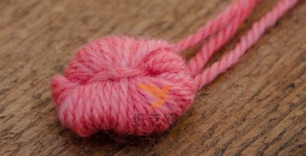 Use a fork to make yarn pom-pom balls