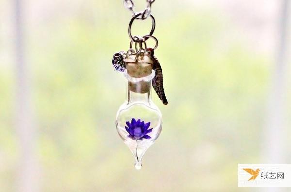 Handmade necklace jewelry made by placing dried flowers in a glass container