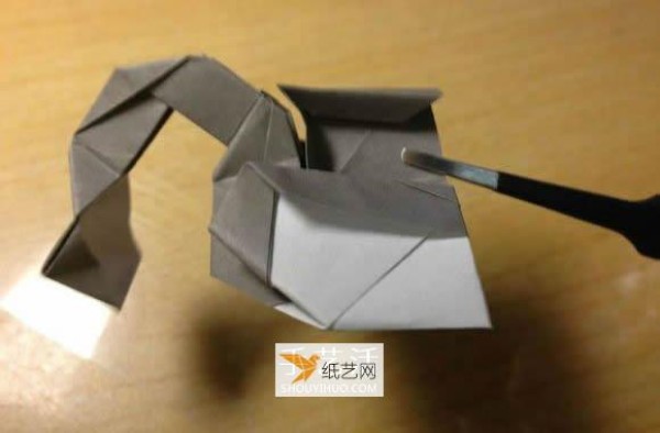 Illustration of the manual folding method of a small origami excavator