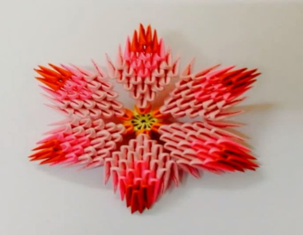 Tutorial on how to make origami triangles with decorative flowers