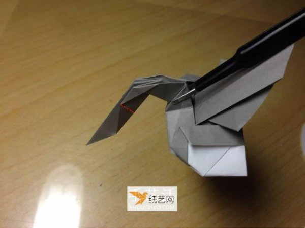 Illustration of the manual folding method of a small origami excavator