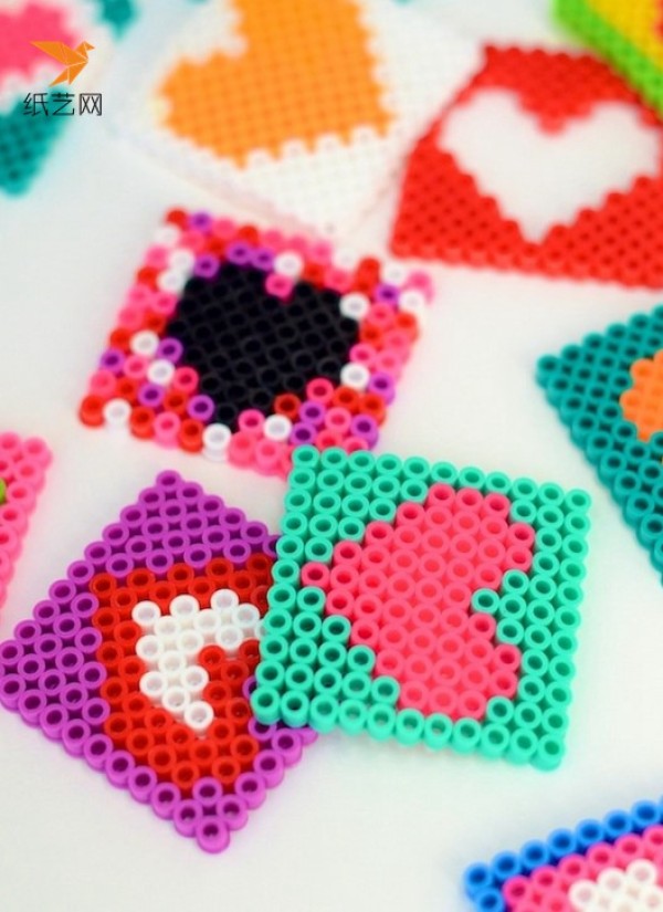 Make Valentine’s Day love coasters with spelled beans