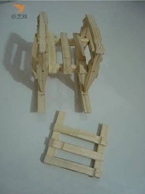 A small wooden chair for dolls made from unused wooden clips in the tutorial on turning waste into treasure