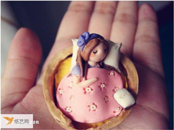 Use polymer clay to make a little girl sleeping in a walnut shell