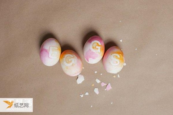 Use watercolor paint and tattoo stickers to create personalized egg decorations