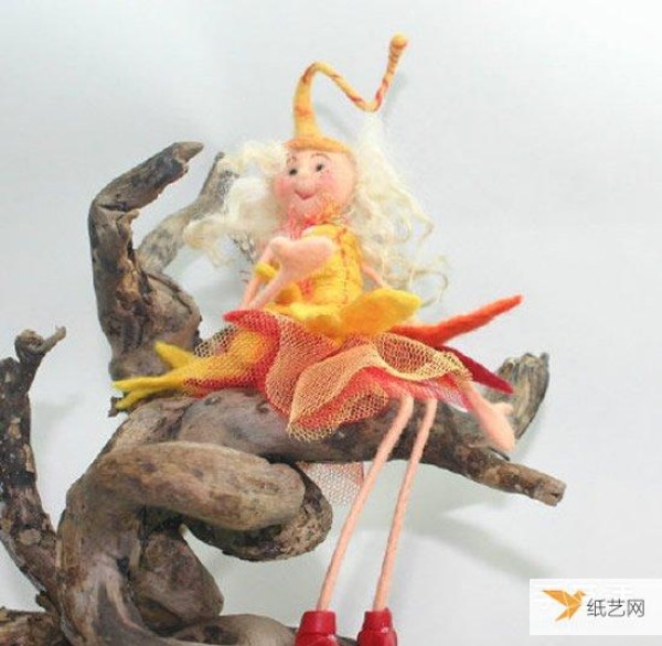 A particularly beautiful cartoon-style picture of a handmade wool felt girl doll