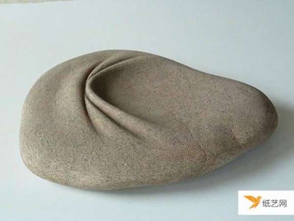 A pair of skillful hands create stone sculptures with smooth and natural curves