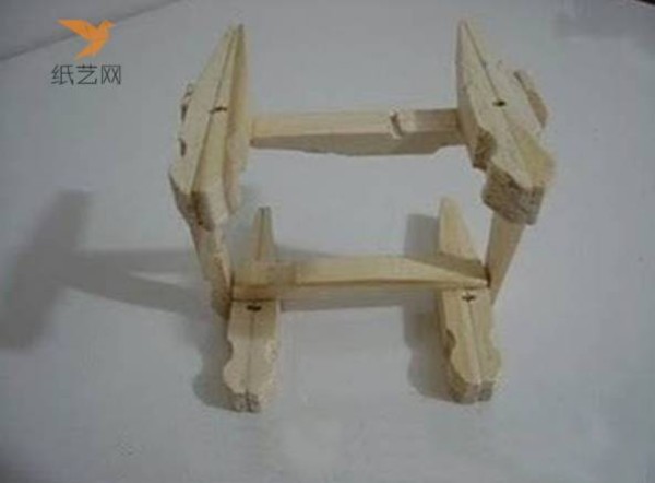 A small wooden chair for dolls made from unused wooden clips in the tutorial on turning waste into treasure