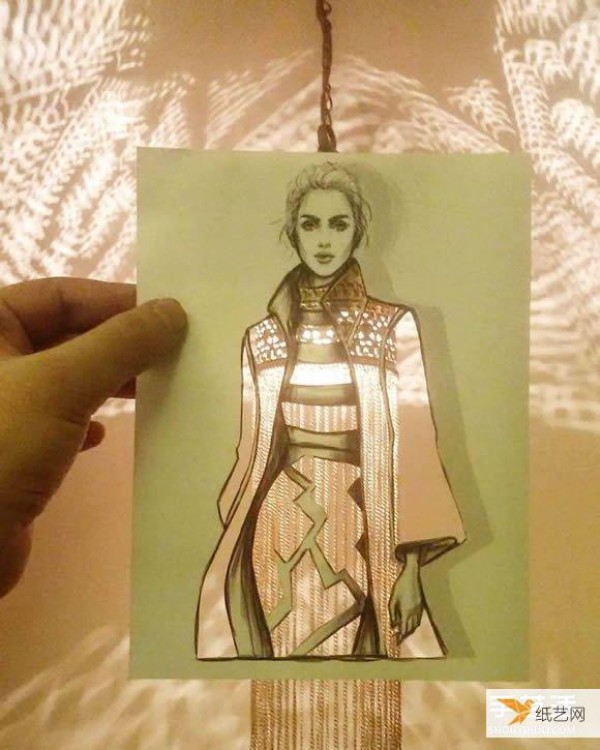 A very unique and creative paper-cut painting that puts the world into a dress!