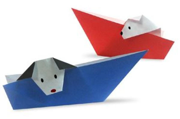 Childrens handmade origami tutorial of puppy sitting on paper boat