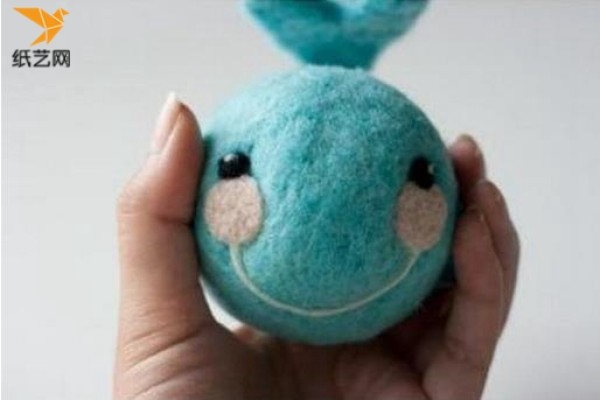 Illustrated tutorial on how to make a cute little whale toy that makes noise with handmade wool felt.