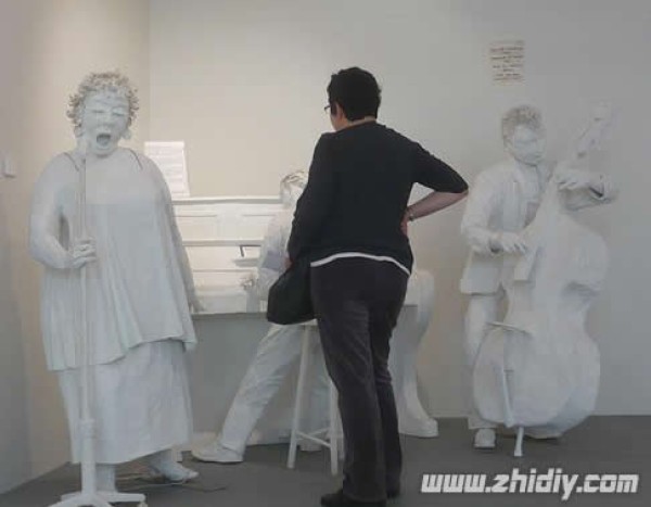 Lifelike paper sculptures of people