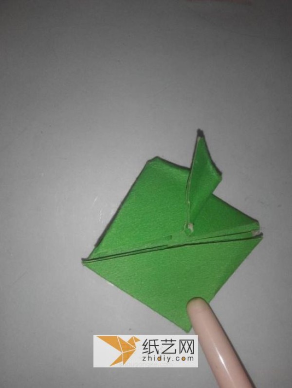 How to fold a jumping frog. A new way to fold a three-dimensional origami frog.