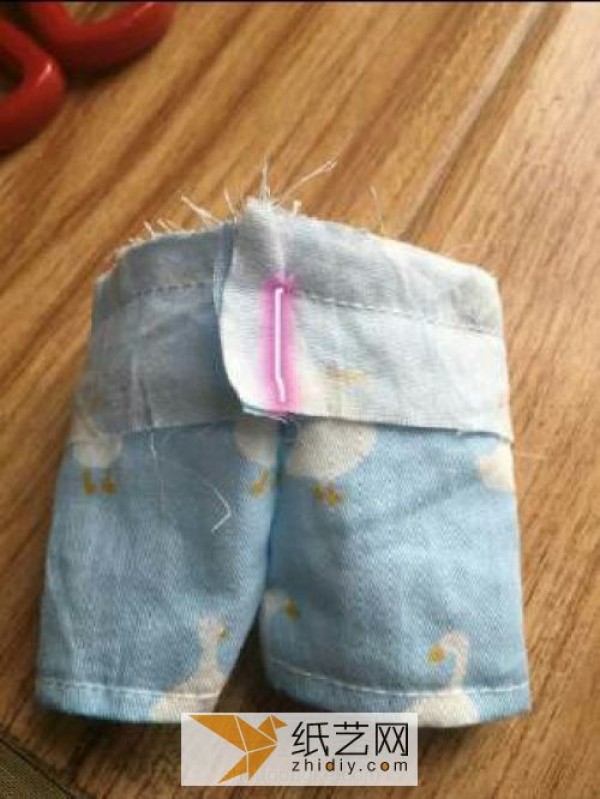 A Childrens Day gift for a doll. A pair of summer suspenders made from fabric.