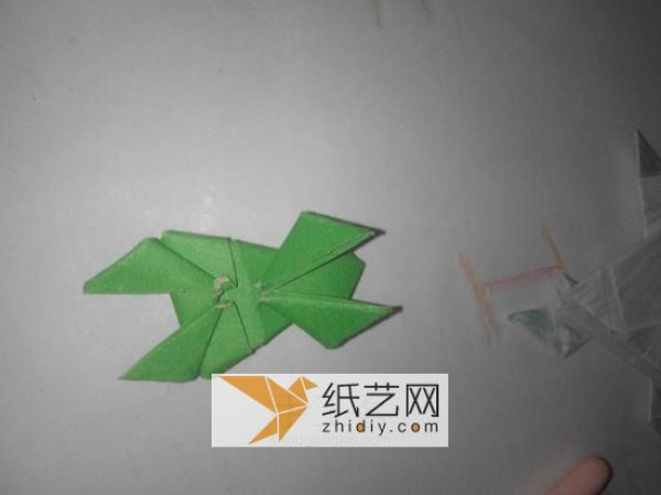 How to fold a jumping frog. A new way to fold a three-dimensional origami frog.