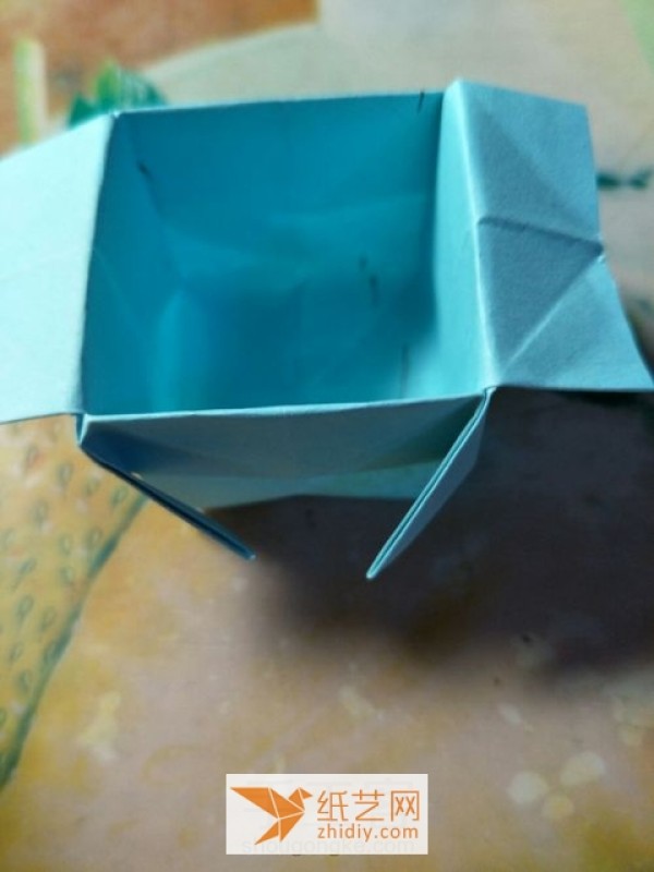 Tutorial on how to make a childrens handmade origami pagoda that quickly transforms into an origami storage box