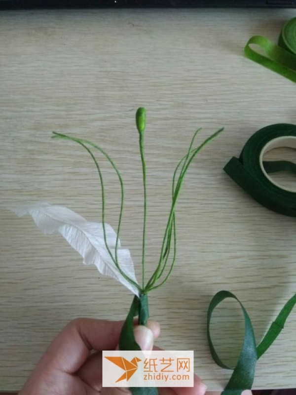 Tutorial illustration of paper art lily New Year decoration made from crepe paper