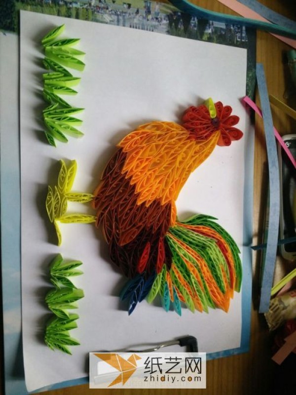 Illustration of the paper drawing tutorial of a big rooster made with quill paper. A New Year’s gift for the Year of the Rooster.