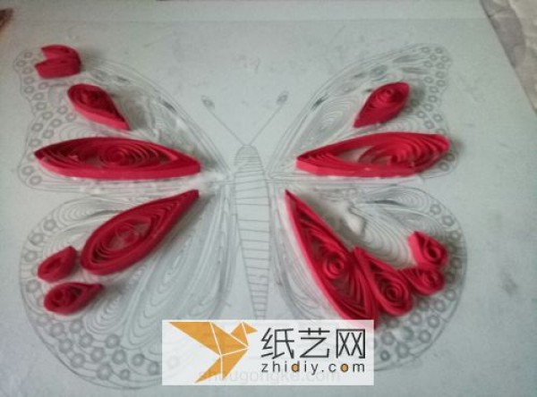 Making spring handmade three-dimensional small butterflies from quilled paper