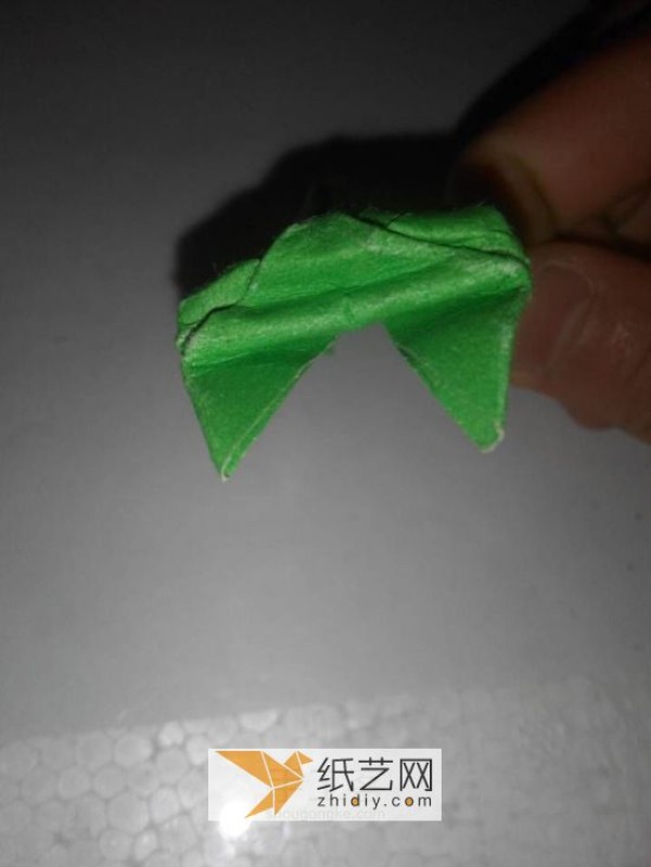 How to fold a jumping frog. A new way to fold a three-dimensional origami frog.