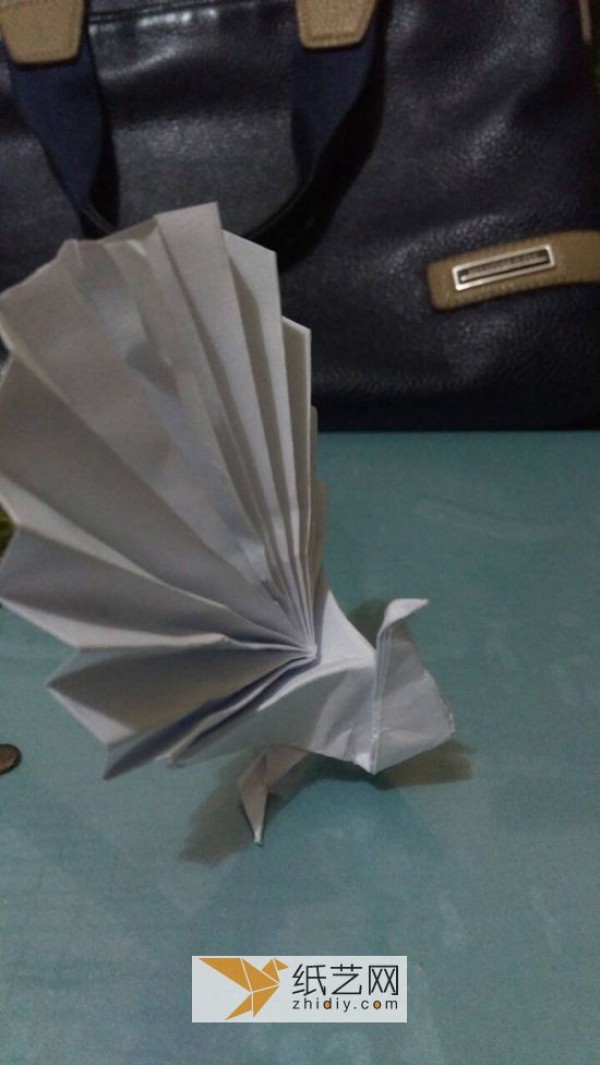 An origami peacock with its tail open