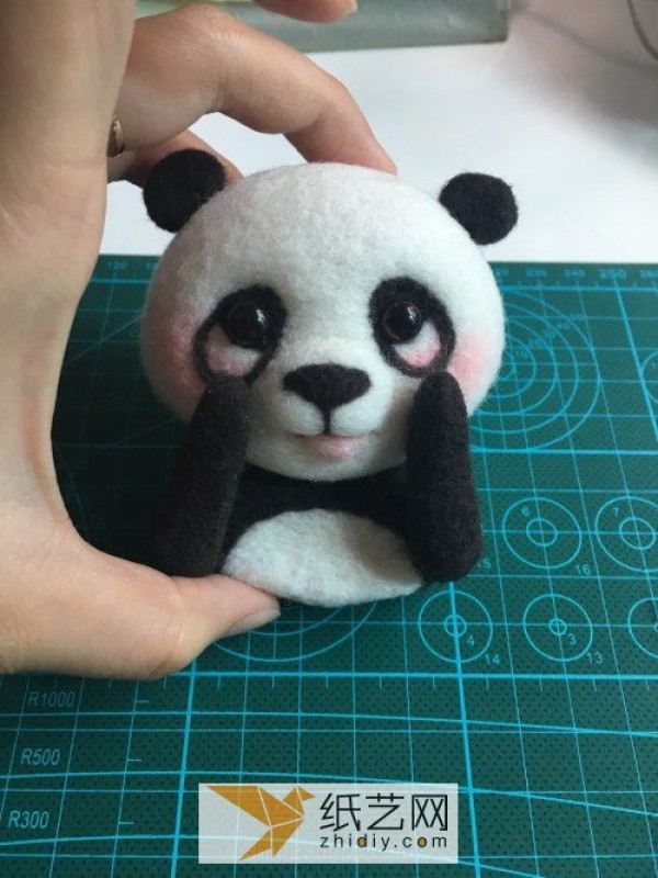 Tutorial on how to make a red panda making a wool felt car ornament, a fun Mother’s Day gift