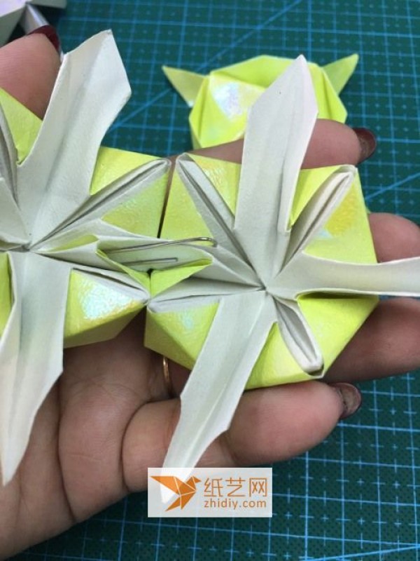 A step-by-step tutorial on how to make origami holiday lanterns