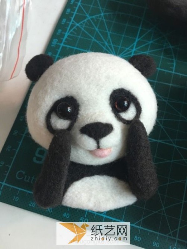 Tutorial on how to make a red panda making a wool felt car ornament, a fun Mother’s Day gift