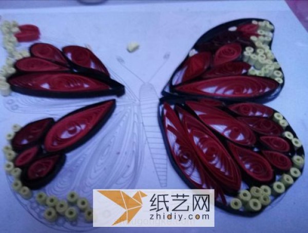 Making spring handmade three-dimensional small butterflies from quilled paper