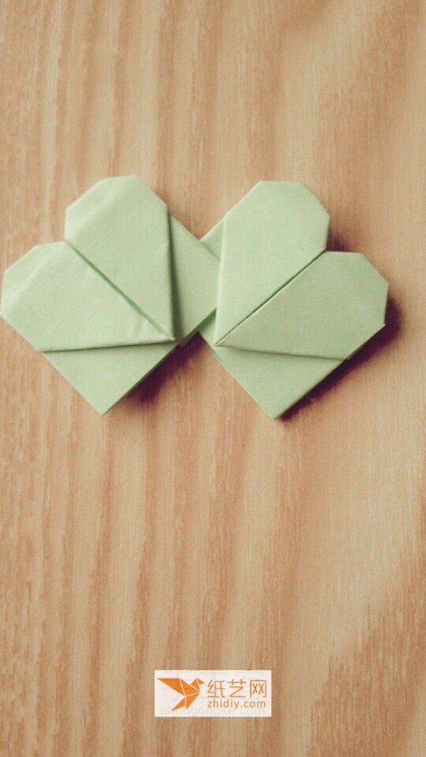 Origami four-leaf clover made of origami hearts. A four-leaf clover full of love.