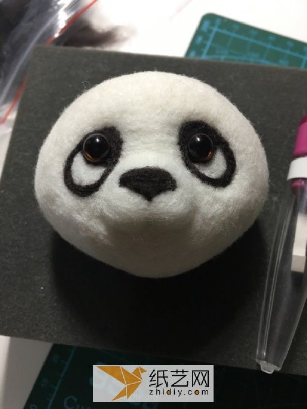 Tutorial on how to make a red panda making a wool felt car ornament, a fun Mother’s Day gift