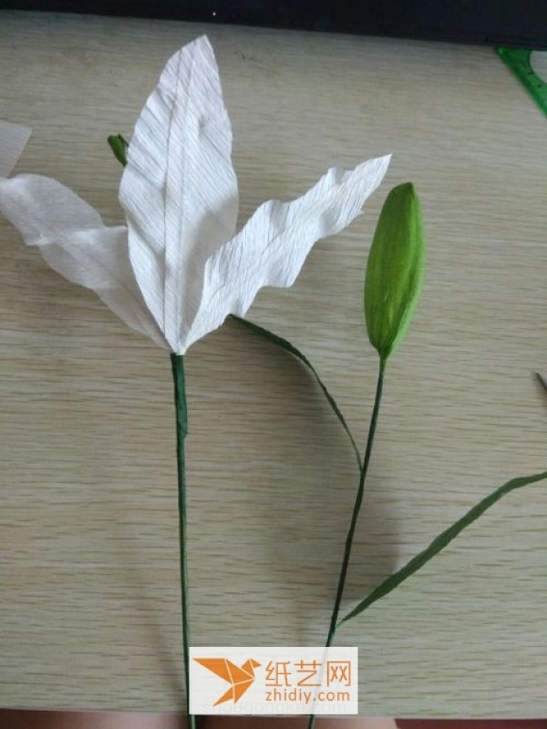 Tutorial illustration of paper art lily New Year decoration made from crepe paper