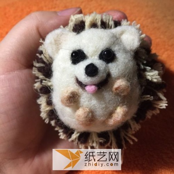 Happy little hedgehog doll made from wool felt and yarn balls