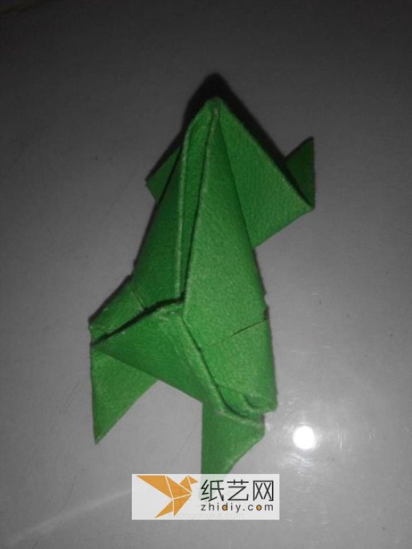 How to fold a jumping frog. A new way to fold a three-dimensional origami frog.