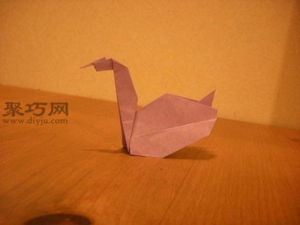 Illustration of handmade origami swan. How to fold a three-dimensional swan.