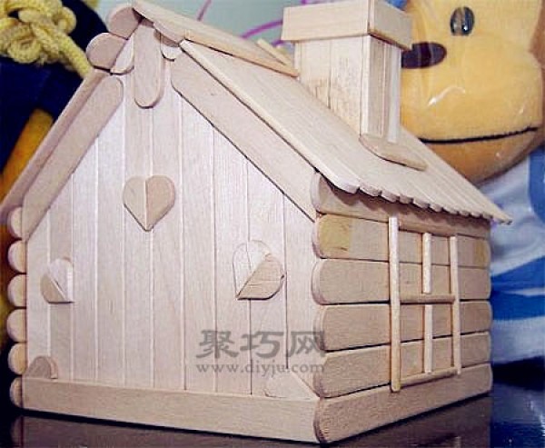 DIY cute little house made of ice cream sticks. Handmade wooden house made of ice cream sticks.