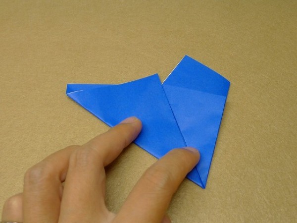 How to cut and fold a pentagon. Illustration of the steps to fold a square origami into a pentagon.