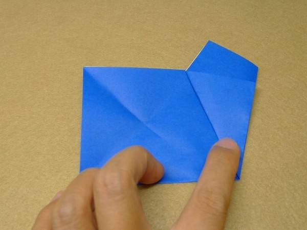 How to cut and fold a pentagon. Illustration of the steps to fold a square origami into a pentagon.