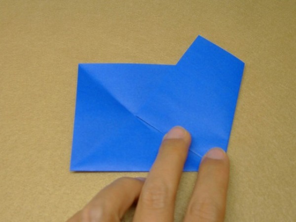 How to cut and fold a pentagon. Illustration of the steps to fold a square origami into a pentagon.