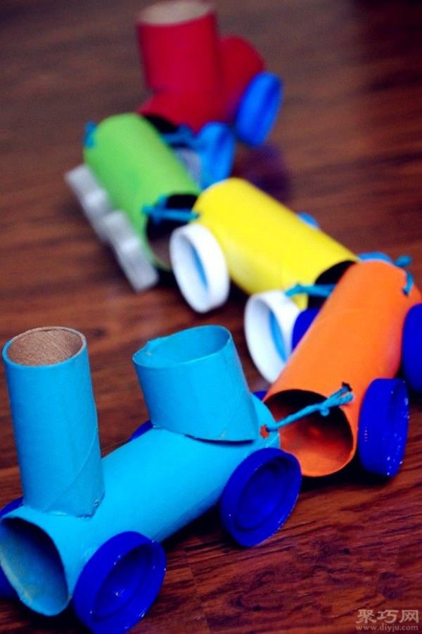 Handmade toy trains made from rolling paper cores and beverage bottle caps