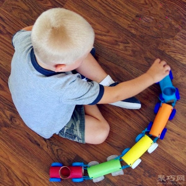 Handmade toy trains made from rolling paper cores and beverage bottle caps