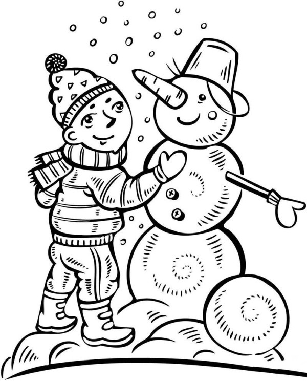 Little boy making a snowman