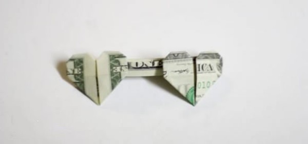 How to fold one dollar origami with two hearts. Illustrated tutorial on folding two hearts with money.