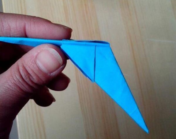 Illustration of the steps for folding a swallow paper airplane